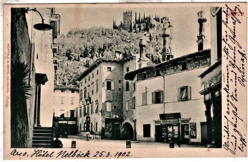 Cartolina antica Arco Trento piazza Grande castello e negozio L. Neumann